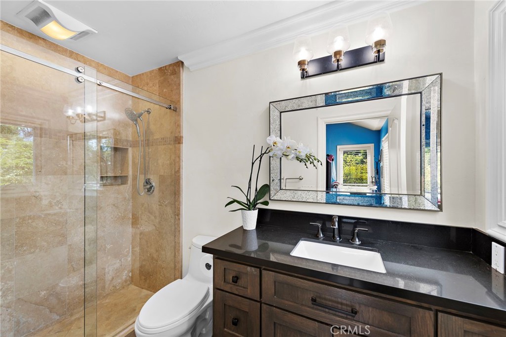 20 Regina Dana Point, CA 92629 - Photo 20 of 26 a bathroom with a granite countertop sink toilet a mirror and shower
