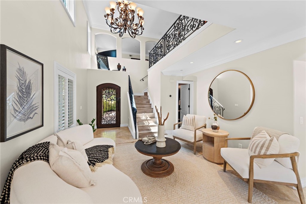 20 Regina Dana Point, CA 92629 - Photo 5 of 26 a living room with furniture a chandelier and fireplace