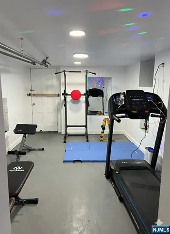 a room with gym equipment and a table