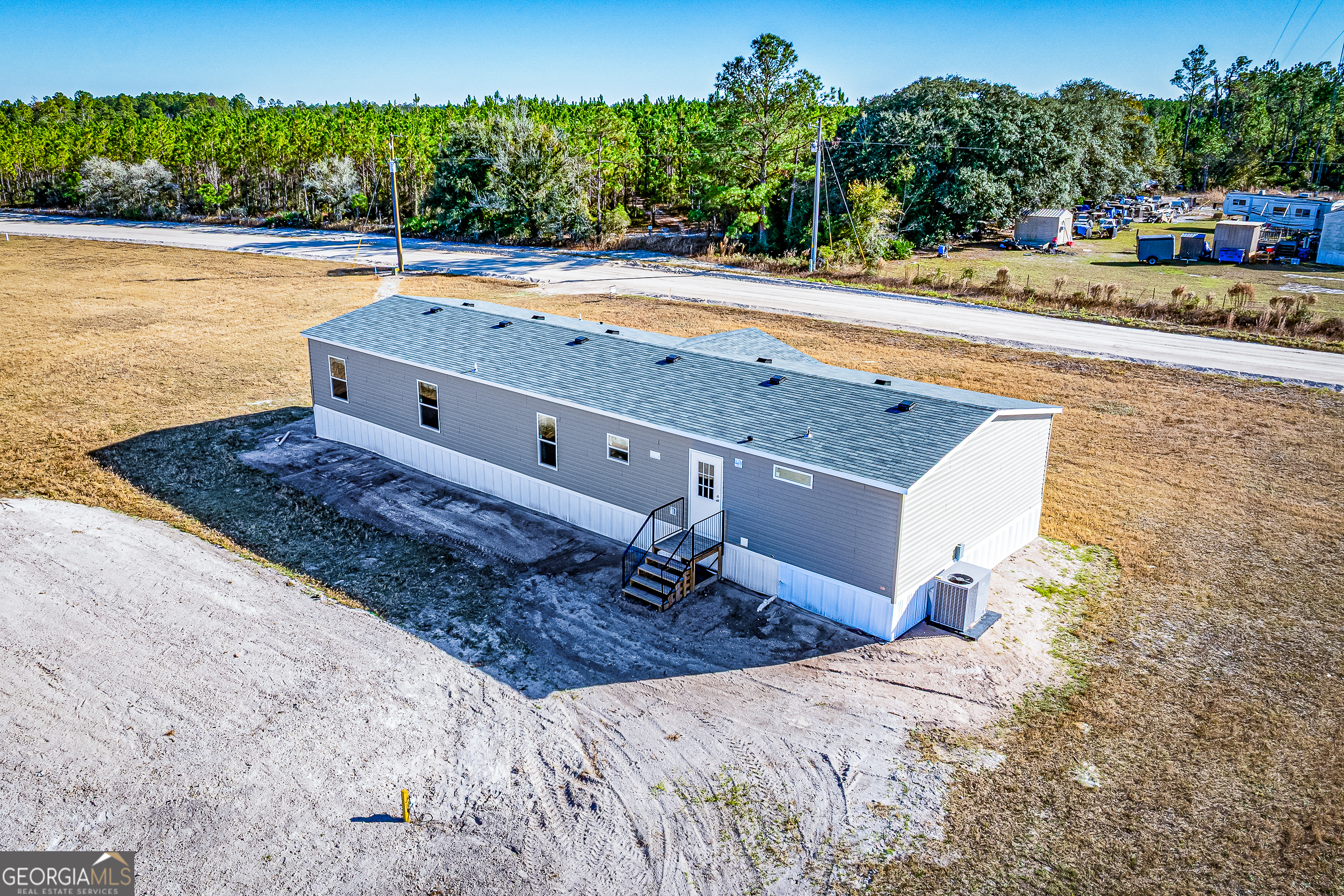 373 Barber Branch St. George, GA 31562 - Photo 23 of 30 a view of a swimming pool with a yard