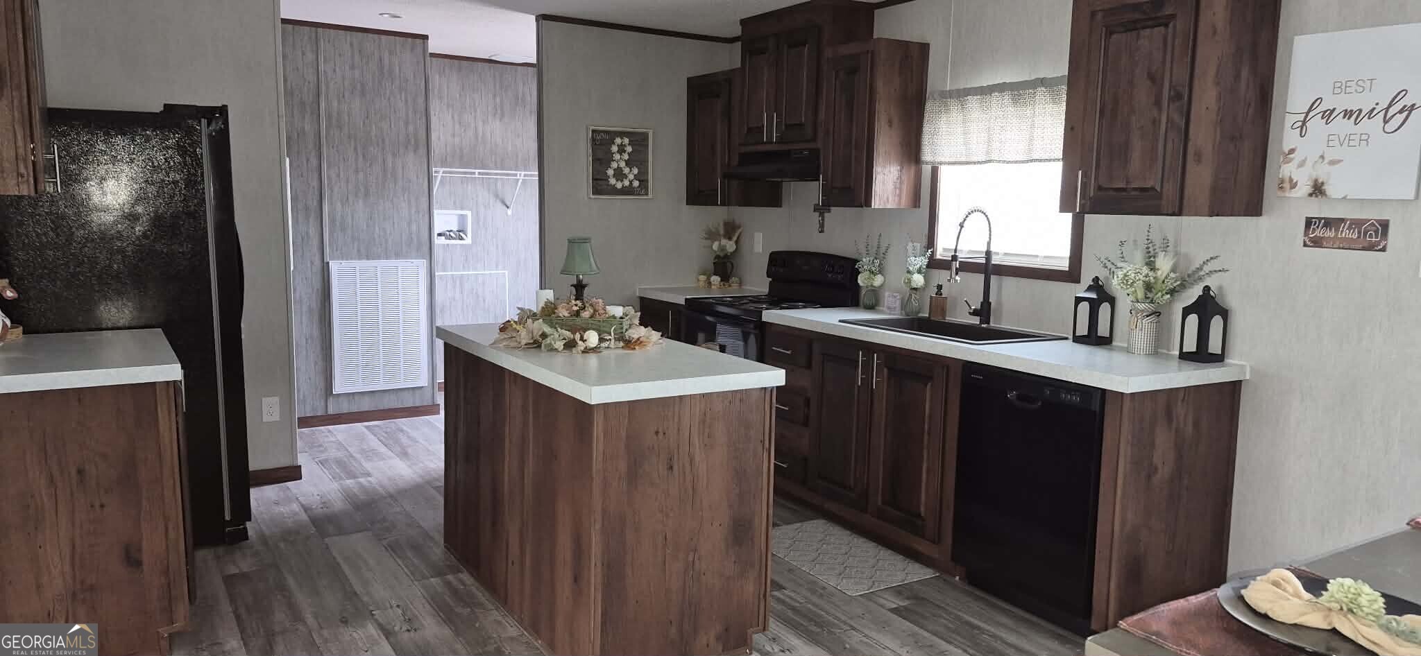 373 Barber Branch St. George, GA 31562 - Photo 7 of 30 a kitchen with a sink stove and cabinets