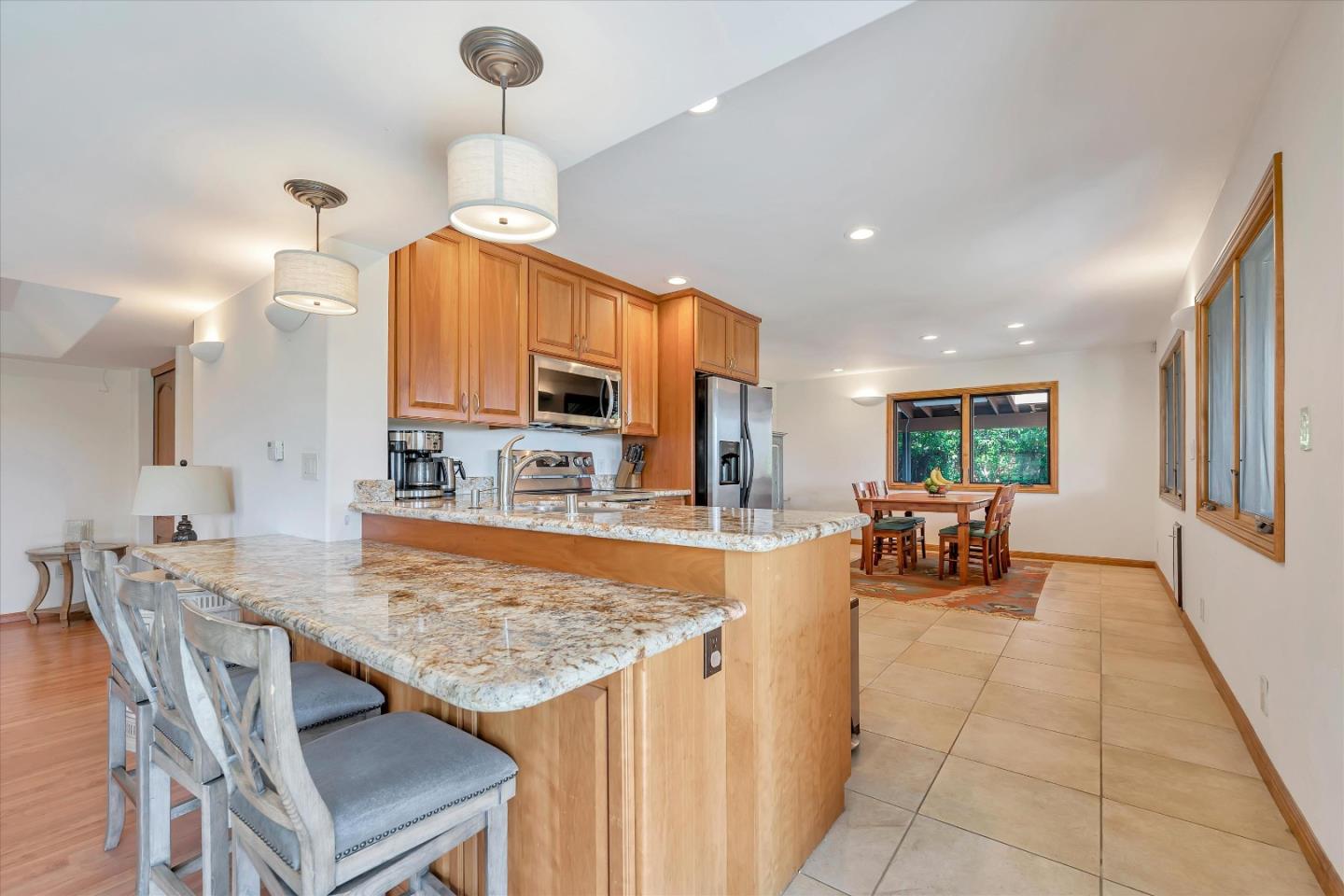 521 Amigo Road Soquel, CA 95073 - Photo 18 of 39 a kitchen with stainless steel appliances granite countertop a stove top oven a sink a dining table and chairs with the view of kitchen