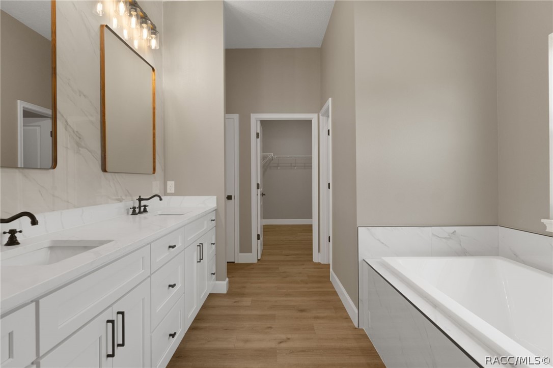 4530 South Florida Avenue Inverness, FL 34450 - Photo 19 of 100 a bathroom with a double vanity sink and mirror with shower