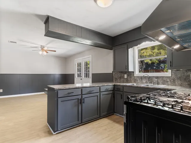 a kitchen with a stove and a sink