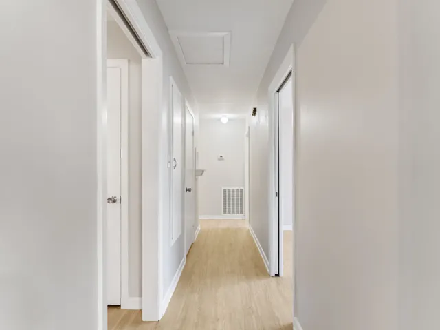 a view of a room with wooden floor