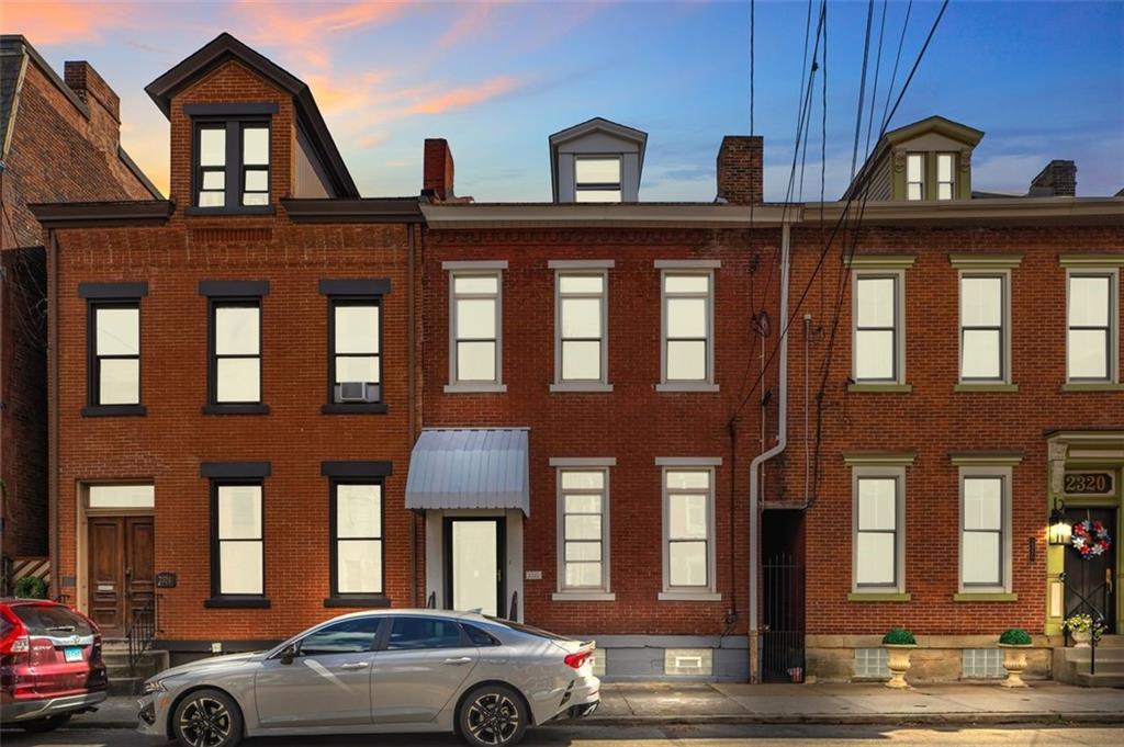 a couple of cars parked in front of a building