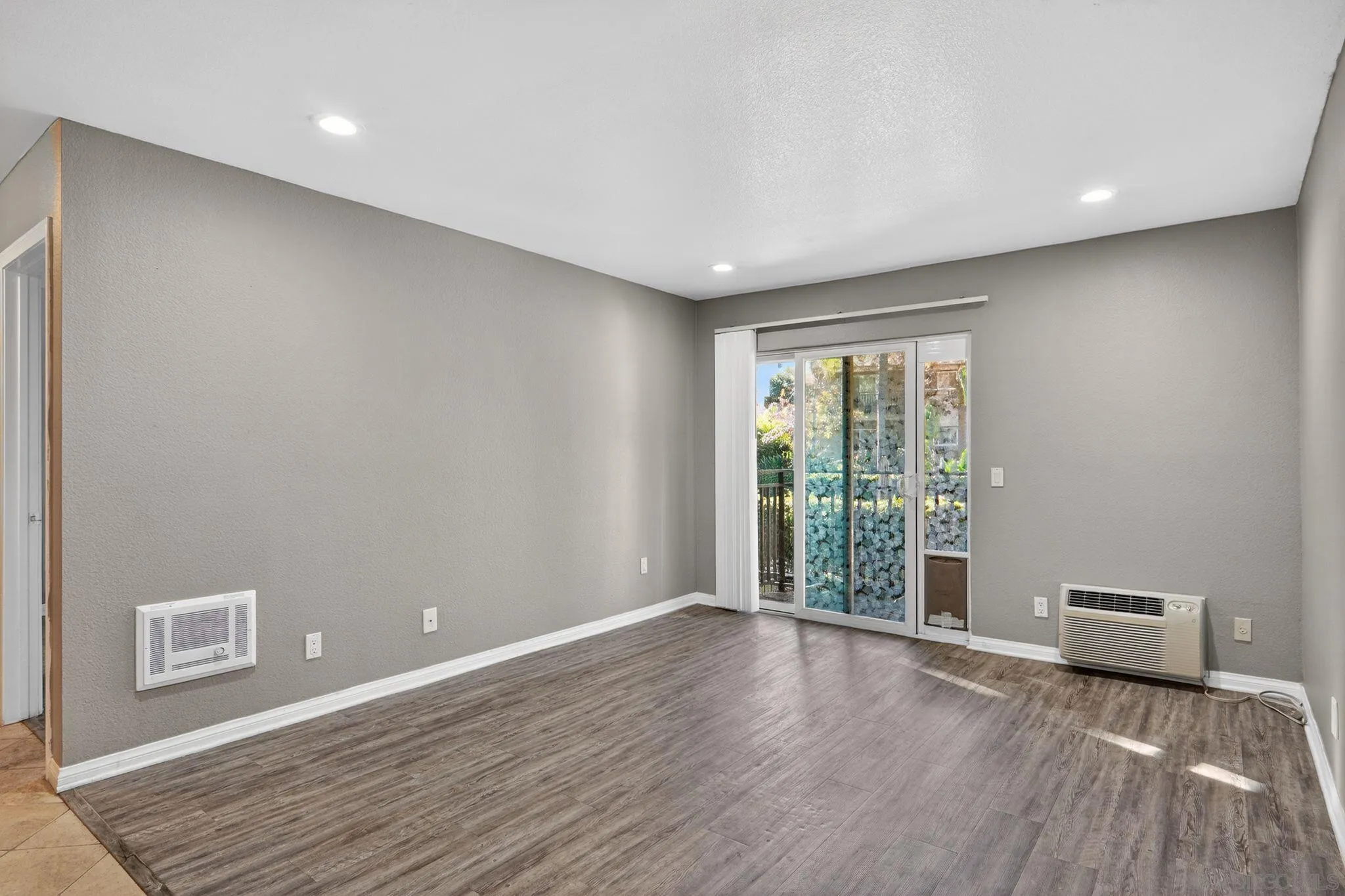 9860 Dale Avenue, Unit B9 Spring Valley, CA 91977 - Photo 12 of 31 a view of an empty room with wooden floor and a window