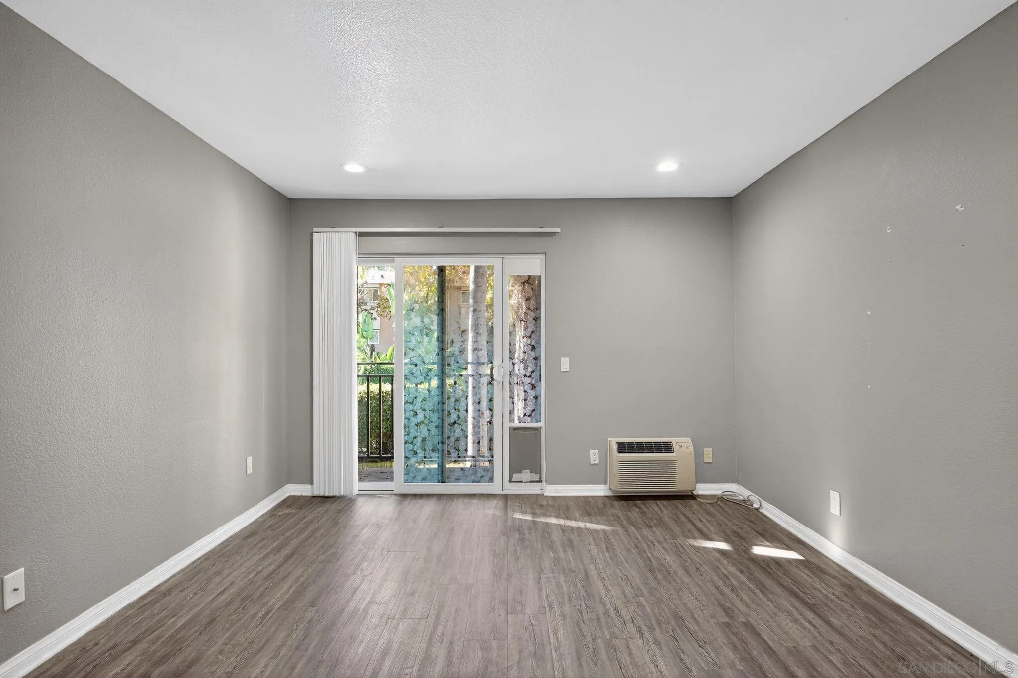 9860 Dale Avenue, Unit B9 Spring Valley, CA 91977 - Photo 17 of 31 an empty room with wooden floor and windows