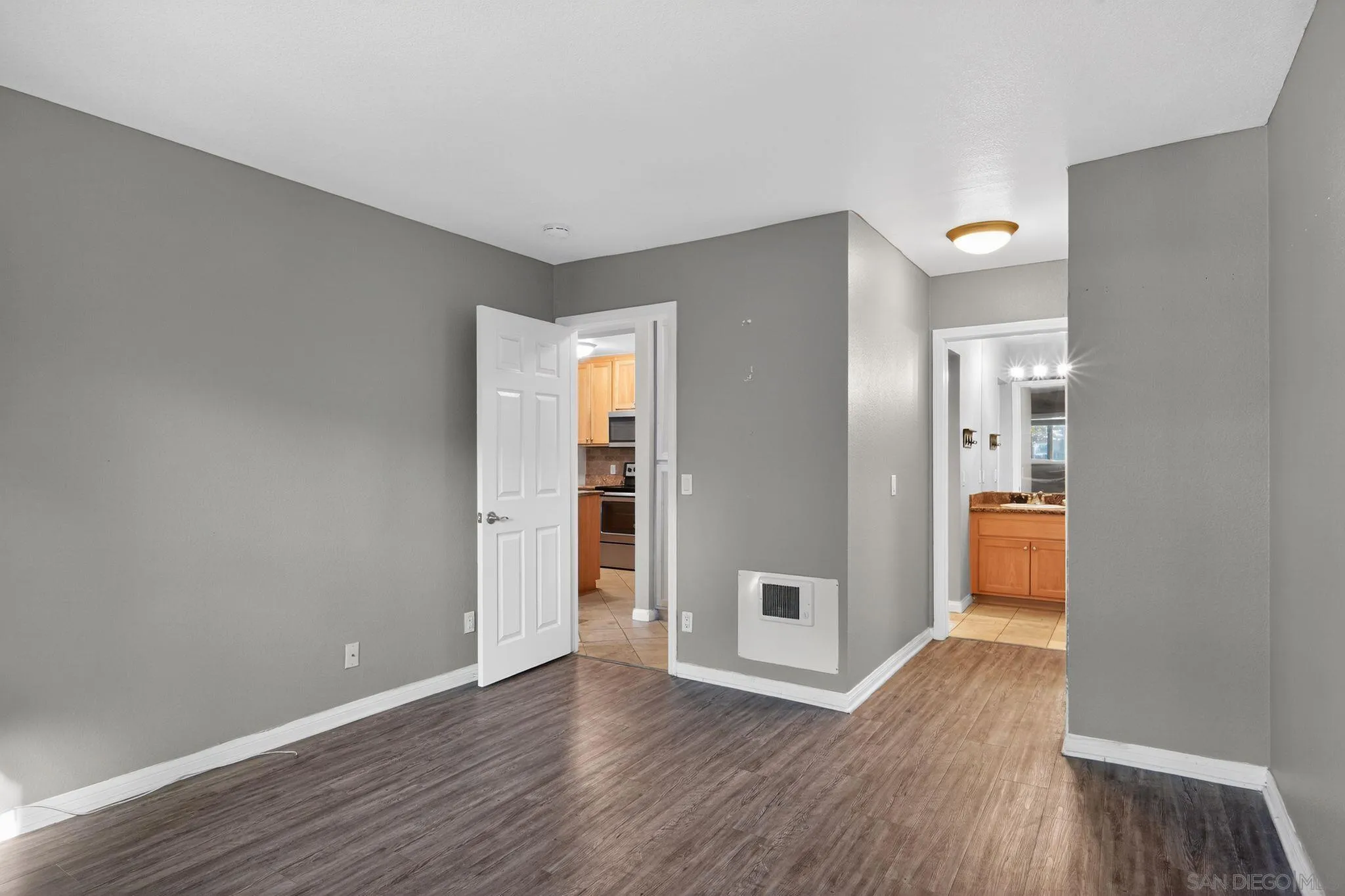 9860 Dale Avenue, Unit B9 Spring Valley, CA 91977 - Photo 19 of 31 a view of a hallway with wooden floor and a kitchen space