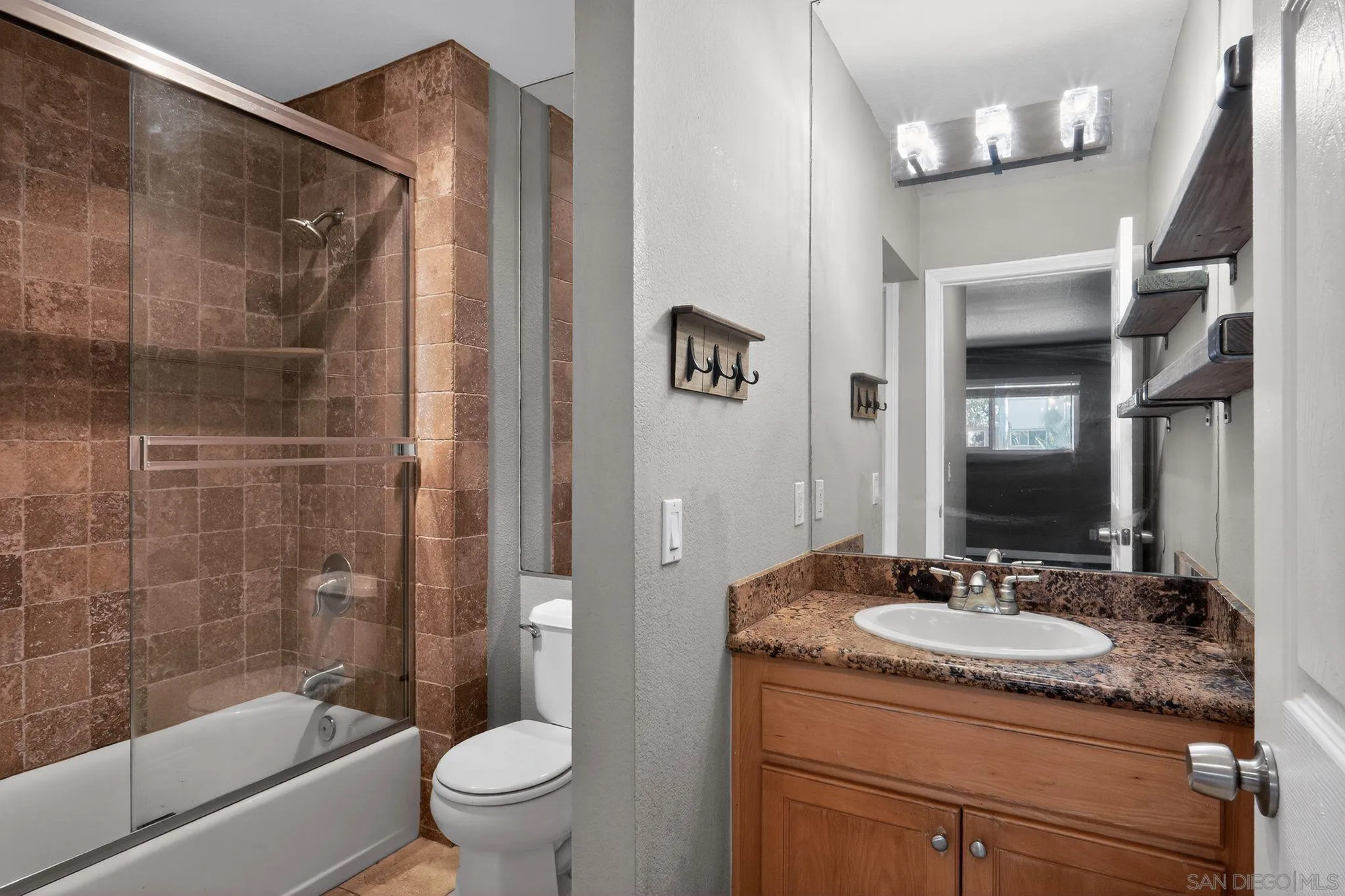 9860 Dale Avenue, Unit B9 Spring Valley, CA 91977 - Photo 22 of 31 a bathroom with a granite countertop sink a toilet and shower