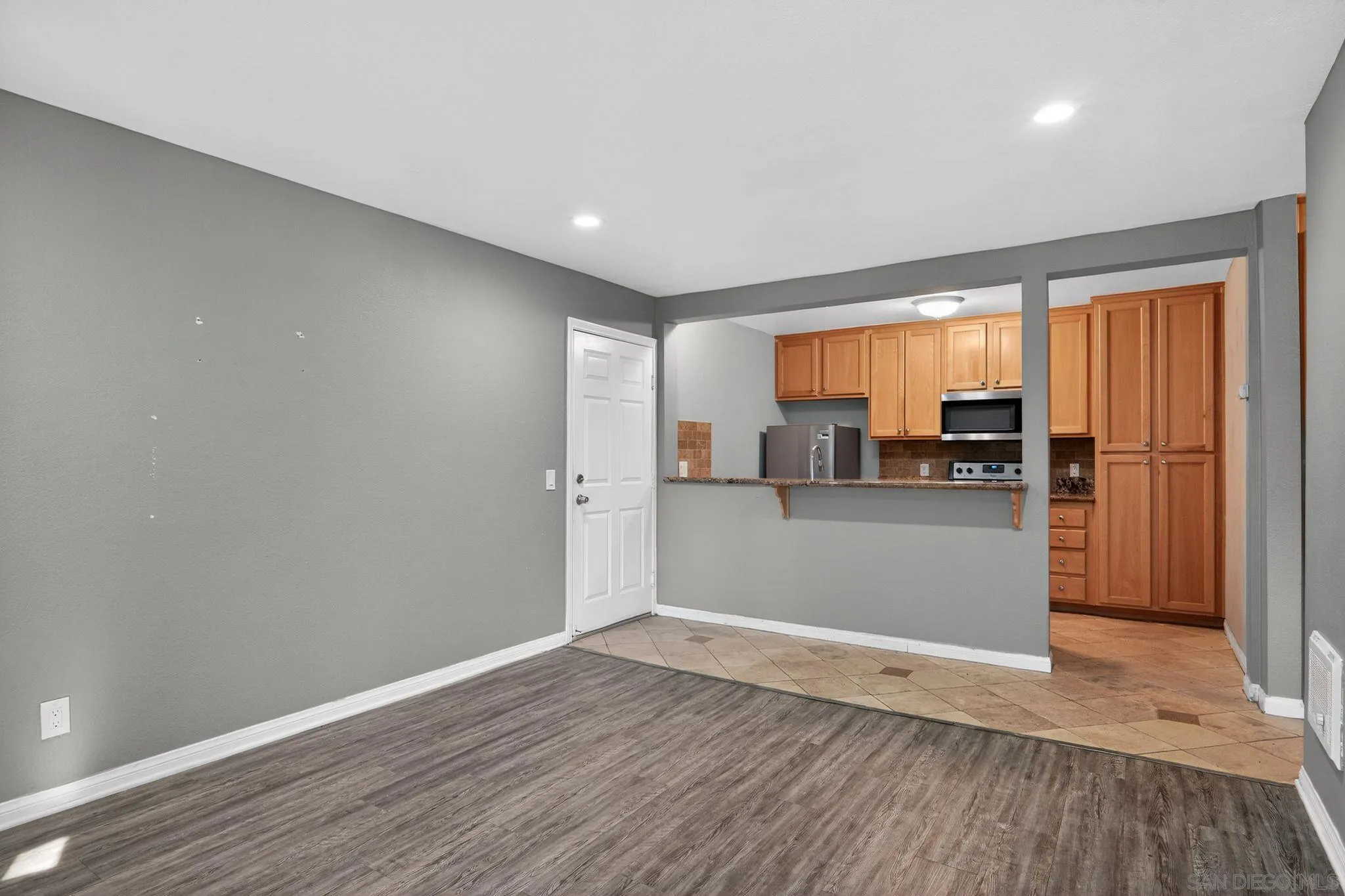 9860 Dale Avenue, Unit B9 Spring Valley, CA 91977 - Photo 5 of 31 a view of a kitchen with a fridge and wooden floor