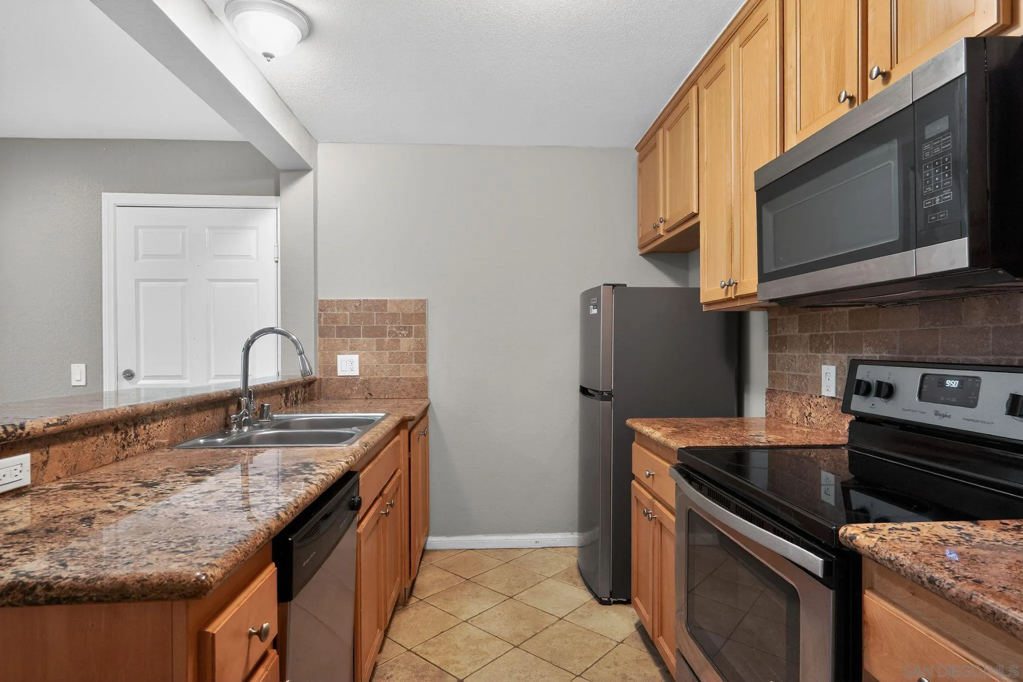 9860 Dale Avenue, Unit B9 Spring Valley, CA 91977 - Photo 9 of 31 a kitchen with stainless steel appliances granite countertop a sink stove and microwave