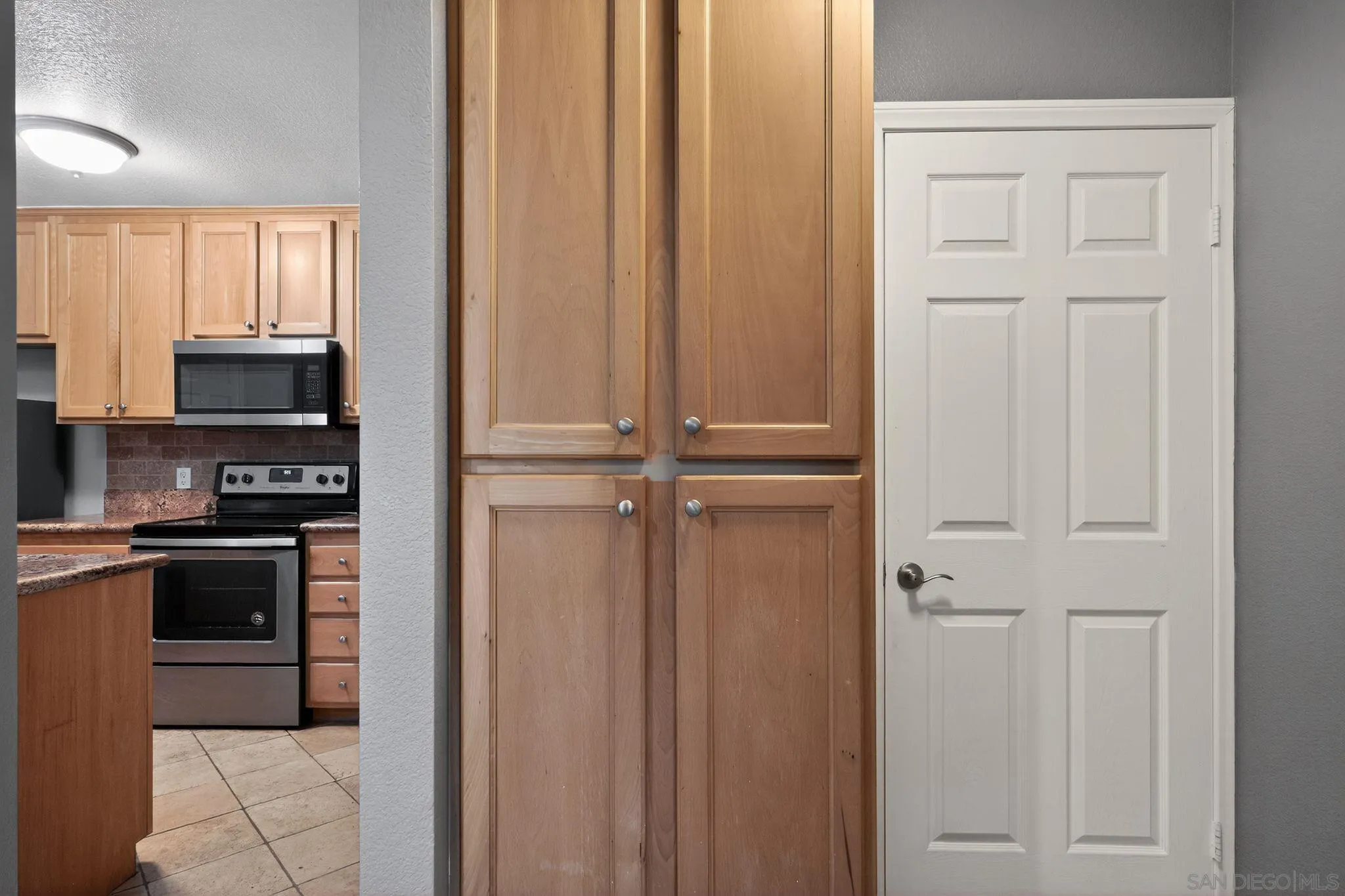 9860 Dale Avenue, Unit B9 Spring Valley, CA 91977 - Photo 10 of 31 a kitchen with stainless steel appliances granite countertop white cabinets and black refrigerator