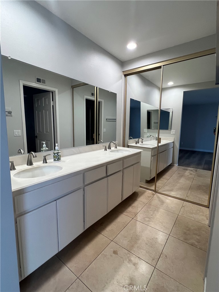 26 Alderbrook Irvine, CA 92604 - Photo 11 of 16 a bathroom with a double vanity sink and a mirror