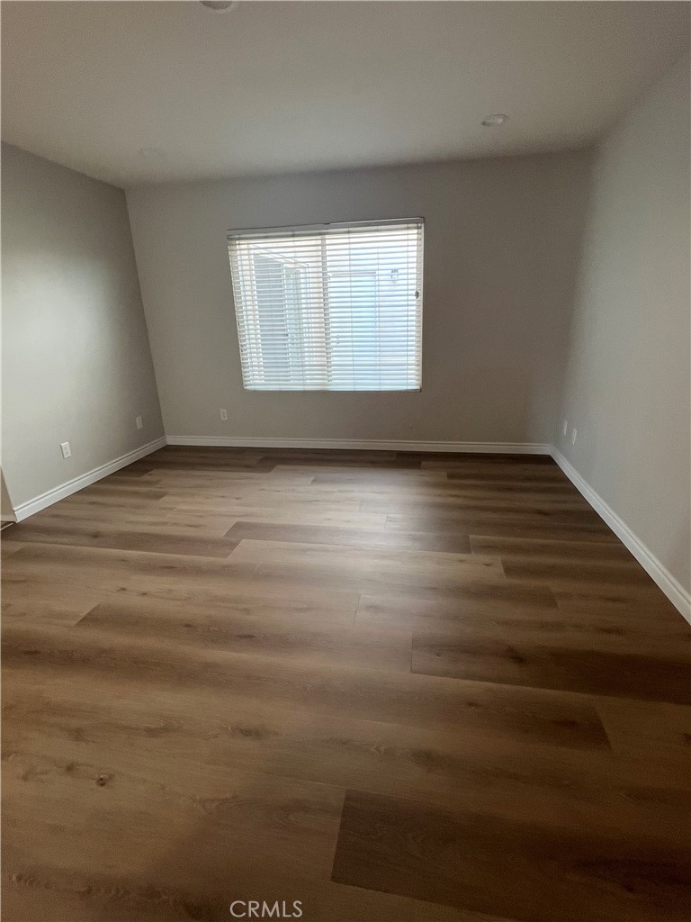 26 Alderbrook Irvine, CA 92604 - Photo 13 of 16 a view of an empty room with wooden floor and a window