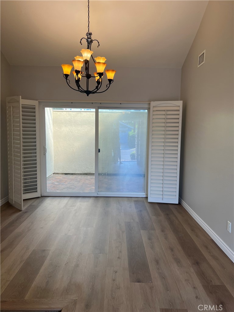 26 Alderbrook Irvine, CA 92604 - Photo 6 of 16 an empty room with wooden floor and windows