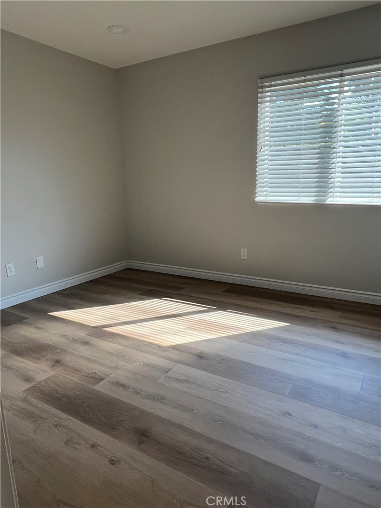 26 Alderbrook Irvine, CA 92604 - Photo 10 of 16 a view of a room with wooden floor and a window