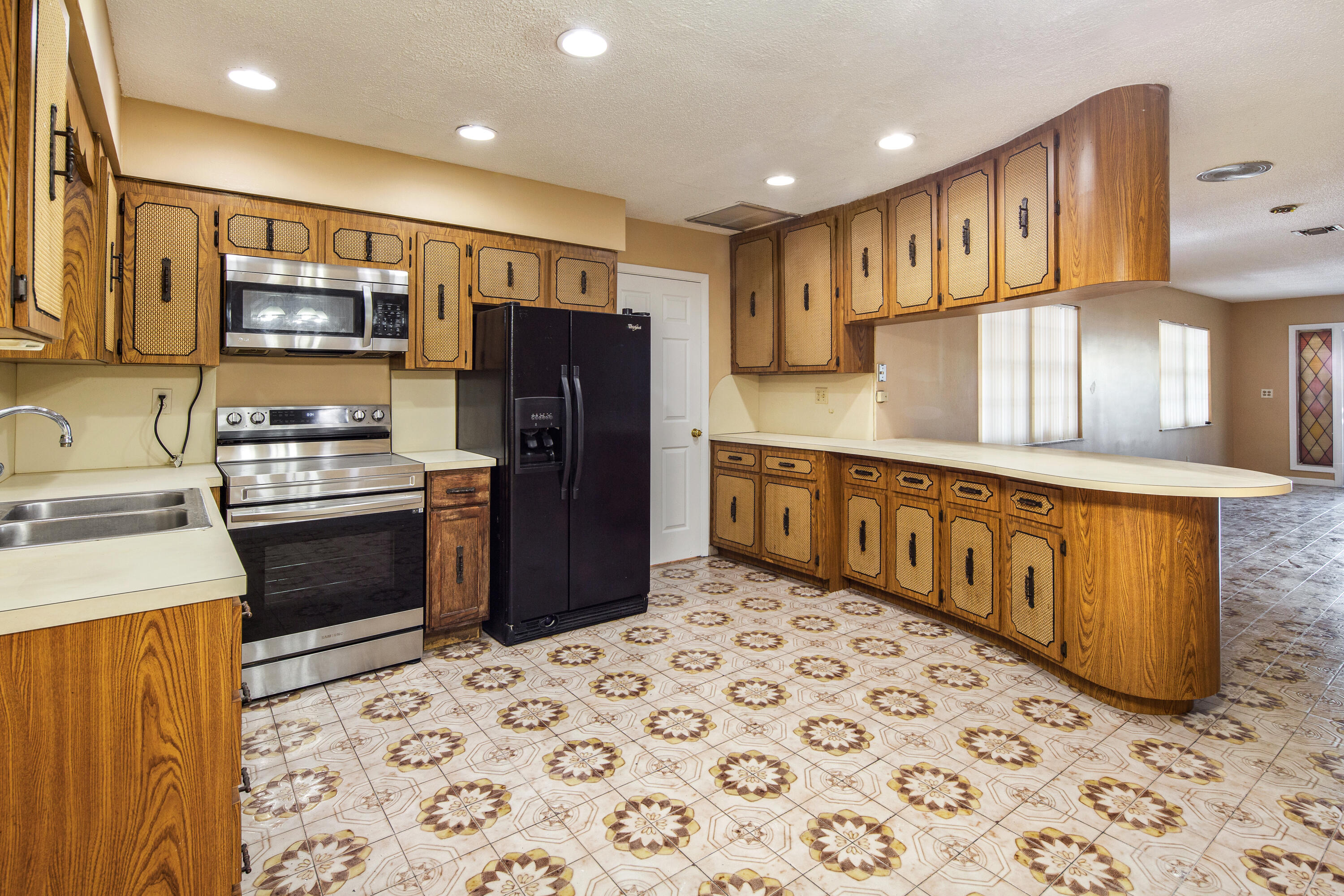1612 Washington Street Key West, FL 33040 - Photo 11 of 38 a kitchen with stainless steel appliances a refrigerator and a stove
