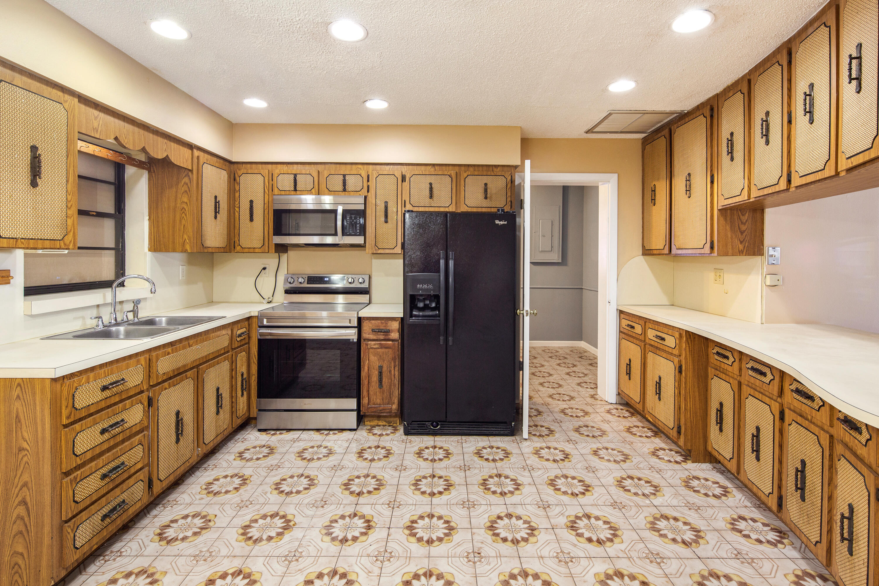1612 Washington Street Key West, FL 33040 - Photo 12 of 38 a kitchen with stainless steel appliances kitchen island granite countertop a refrigerator and a sink