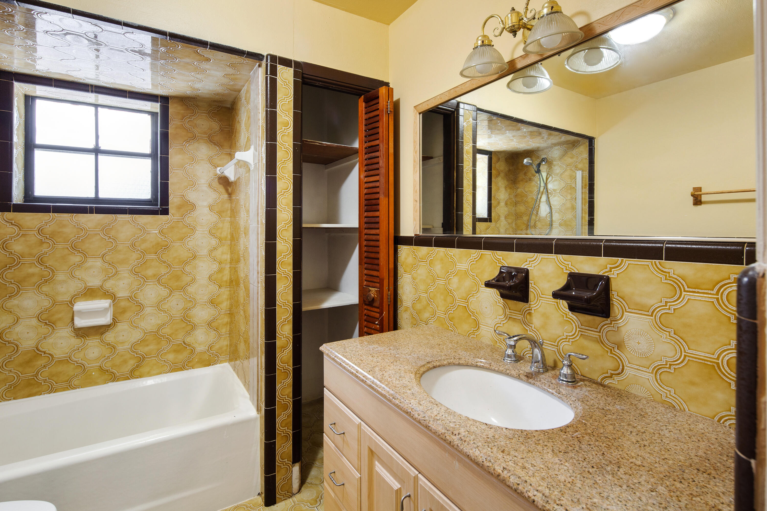 1612 Washington Street Key West, FL 33040 - Photo 20 of 38 a bathroom with a granite countertop sink mirror and a bathtub