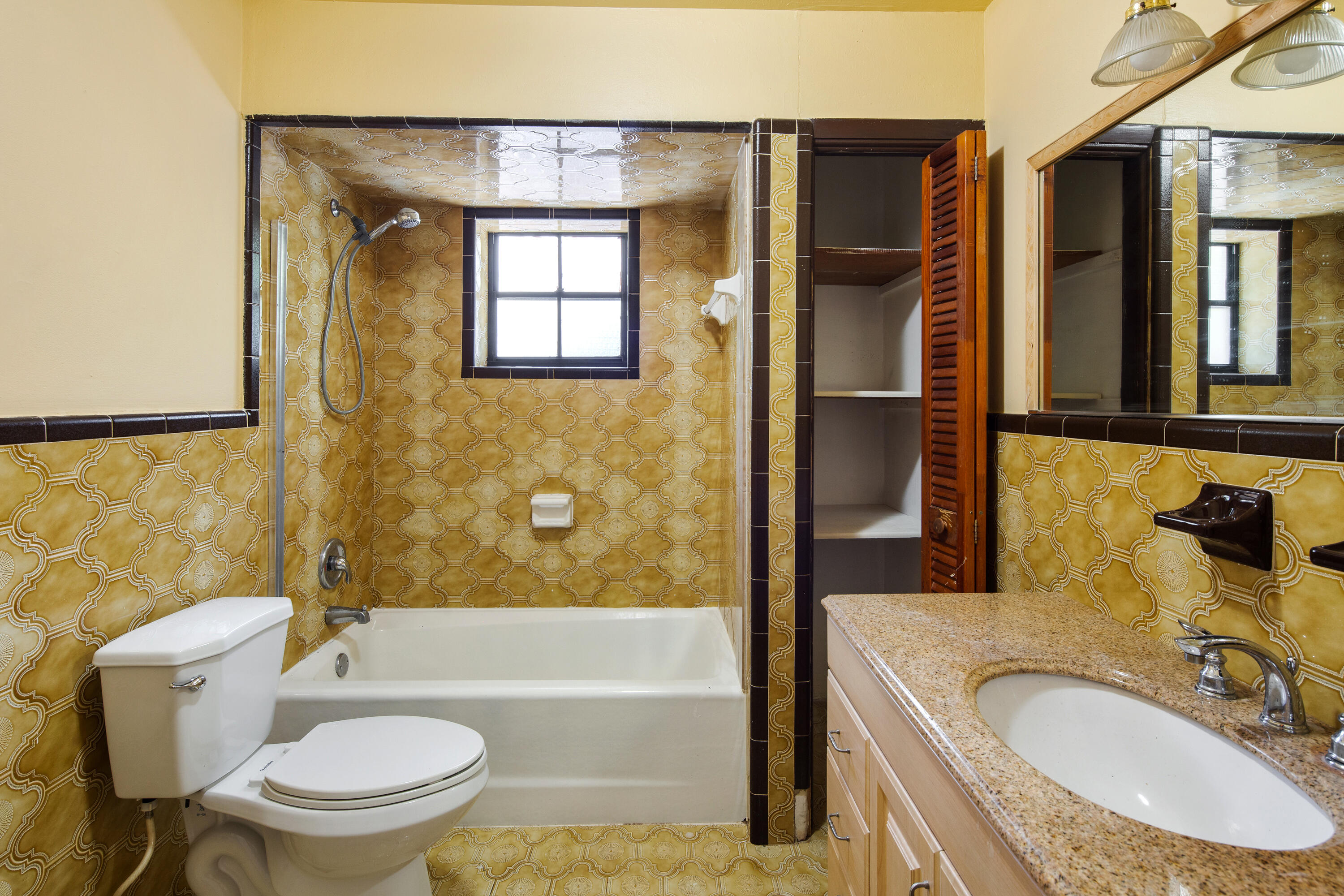 1612 Washington Street Key West, FL 33040 - Photo 21 of 38 a bathroom with a granite countertop toilet sink and mirror
