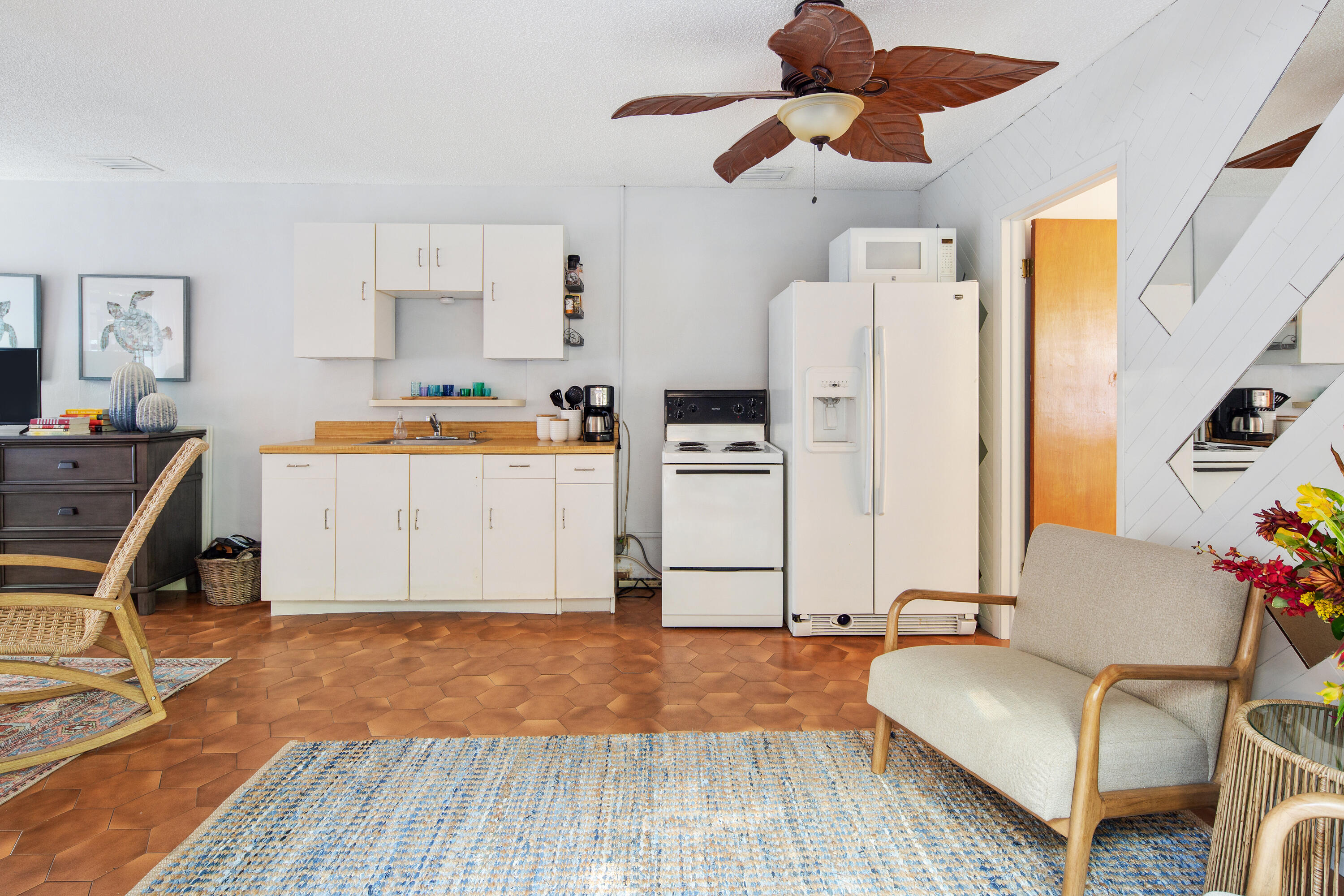 1612 Washington Street Key West, FL 33040 - Photo 29 of 38 a living room with stainless steel appliances kitchen island granite countertop furniture and a wooden floor