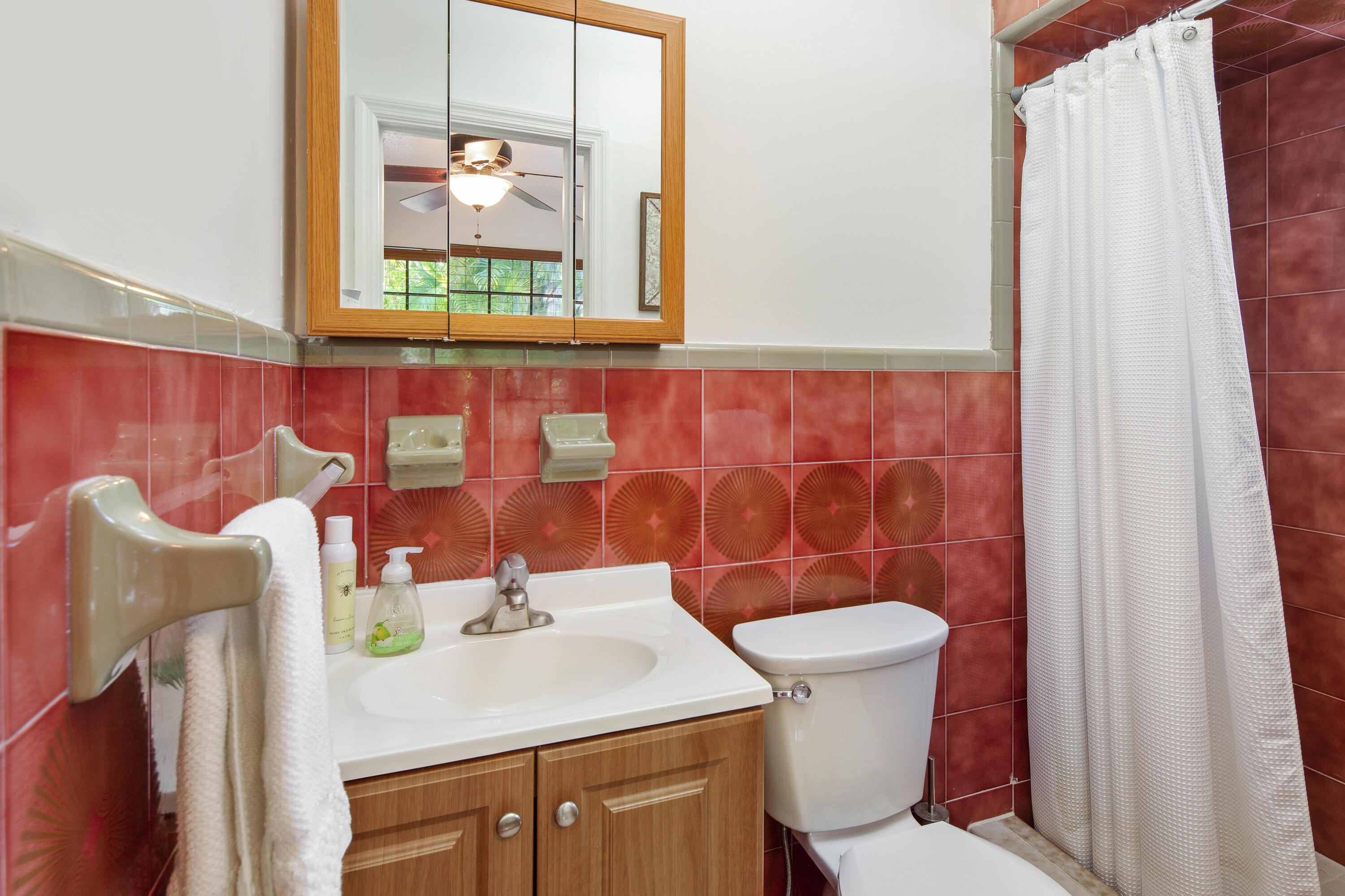 1612 Washington Street Key West, FL 33040 - Photo 32 of 38 a bathroom with a sink a toilet and a mirror