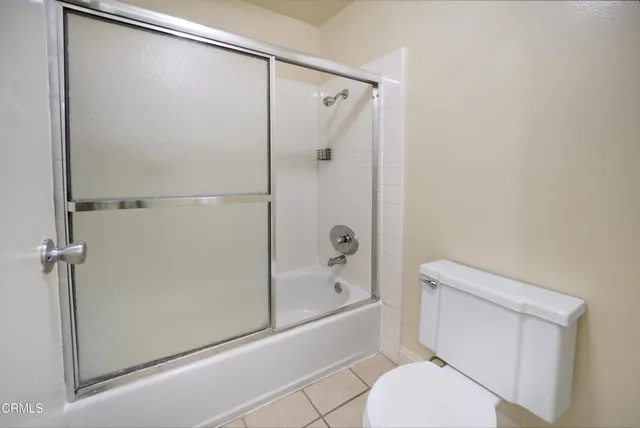 a bathroom with a shower a toilet and a shower