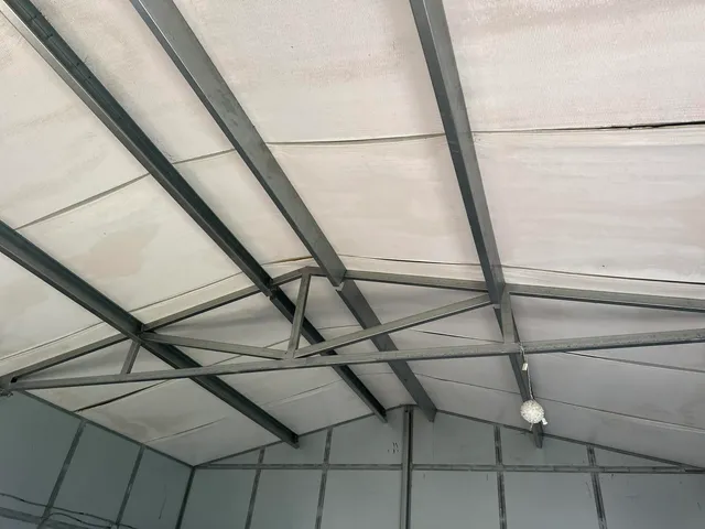 a view of a house with a white fence