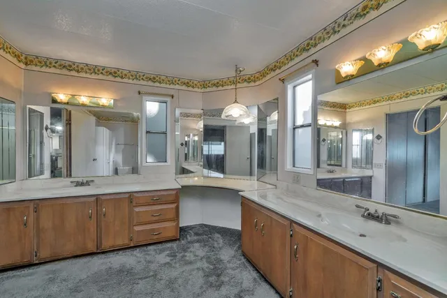 a large bathroom with a large mirror vanity and sink