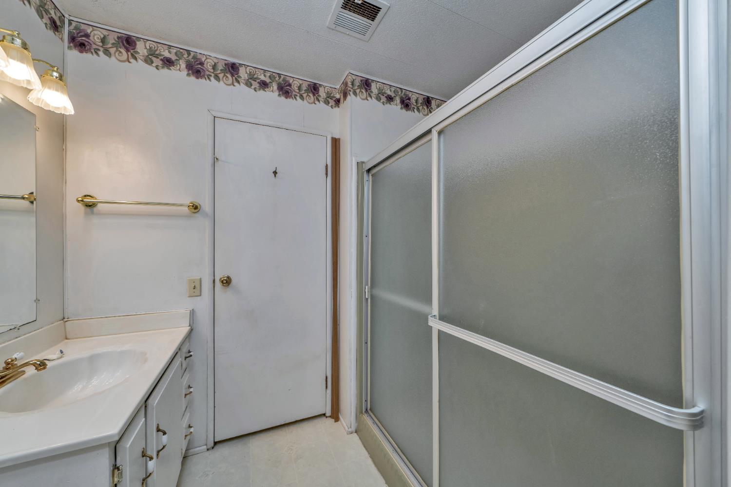 3550 China Garden Road, Unit 38 Placerville, CA 95667 - Photo 7 of 18 a bathroom with a granite countertop sink mirror and shower