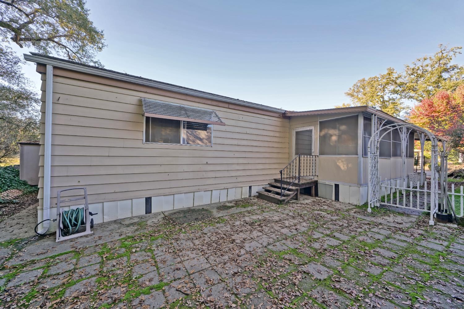 3550 China Garden Road, Unit 38 Placerville, CA 95667 - Photo 10 of 18 a backyard of a house with table and chairs