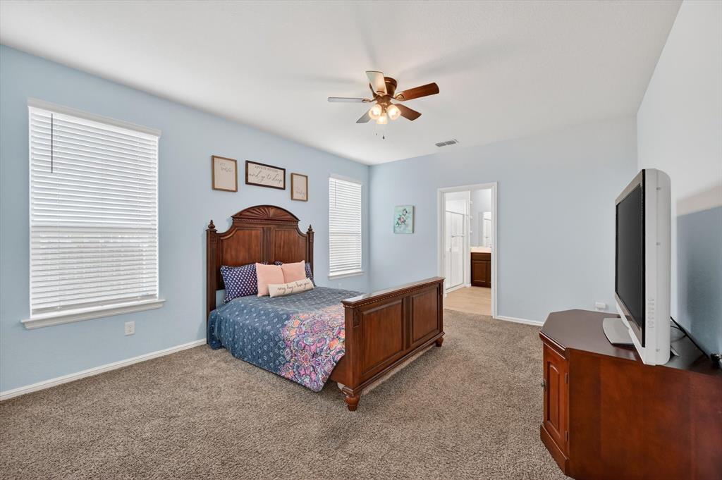 9604 Cherryville Road Fort Worth, TX 76108 - Photo 17 of 40 Spacious bedroom featuring plush carpeting and a neutral color palette