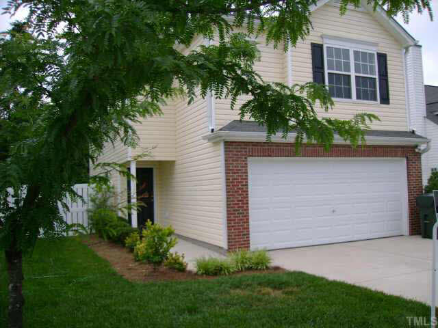 8128 Tara Ridge Road Raleigh, NC 27616 - Photo 2 of 10 a front view of a house with a garden