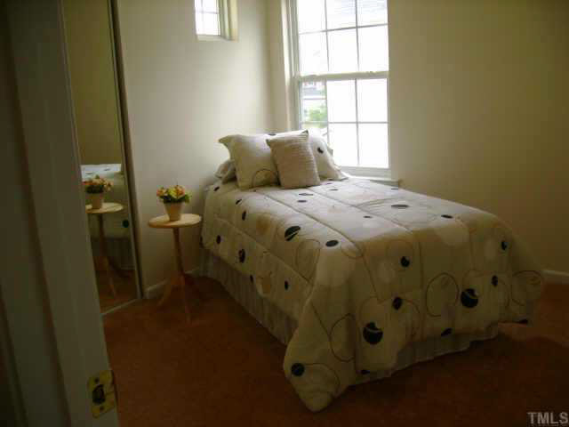 8128 Tara Ridge Road Raleigh, NC 27616 - Photo 3 of 10 a bedroom with a bed and a window