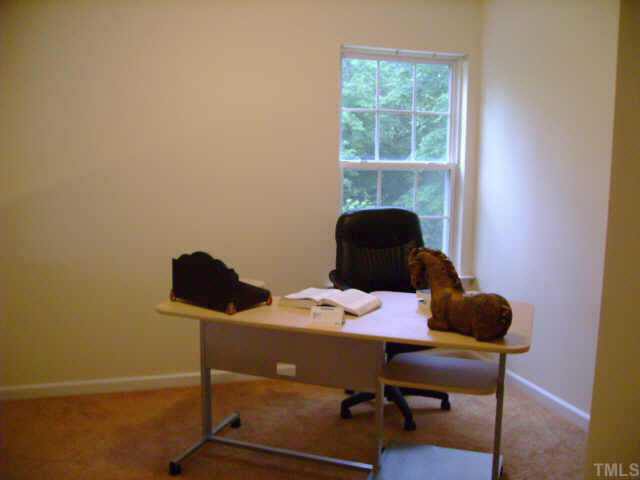 8128 Tara Ridge Road Raleigh, NC 27616 - Photo 5 of 10 a work place with a desk and chair with rug floor