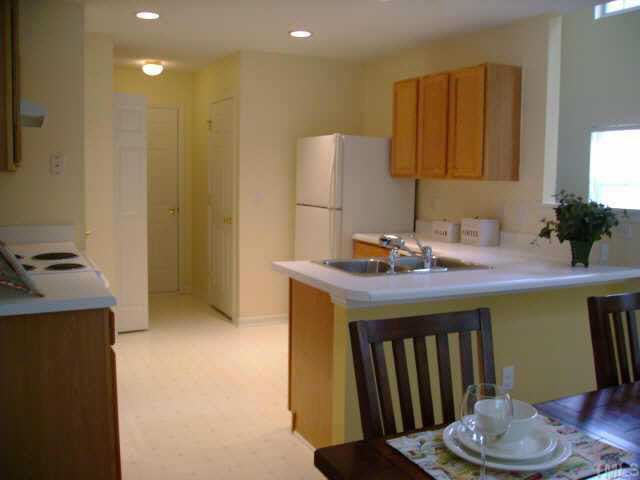 8128 Tara Ridge Road Raleigh, NC 27616 - Photo 6 of 10 a kitchen with a sink and cabinets