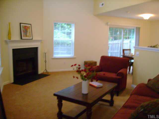 8128 Tara Ridge Road Raleigh, NC 27616 - Photo 8 of 10 a living room with furniture and a fireplace