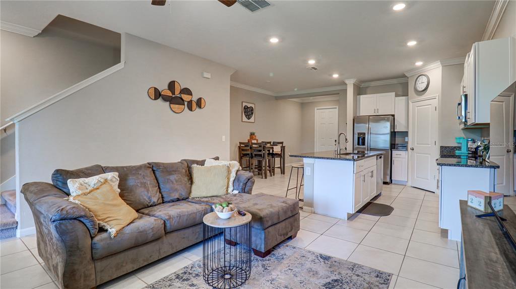 31632 Blue Passing Loop Wesley Chapel, FL 33545 - Photo 19 of 48 a living room with furniture kitchen view and a wooden floor