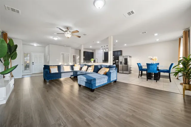 a living room with furniture and kitchen view