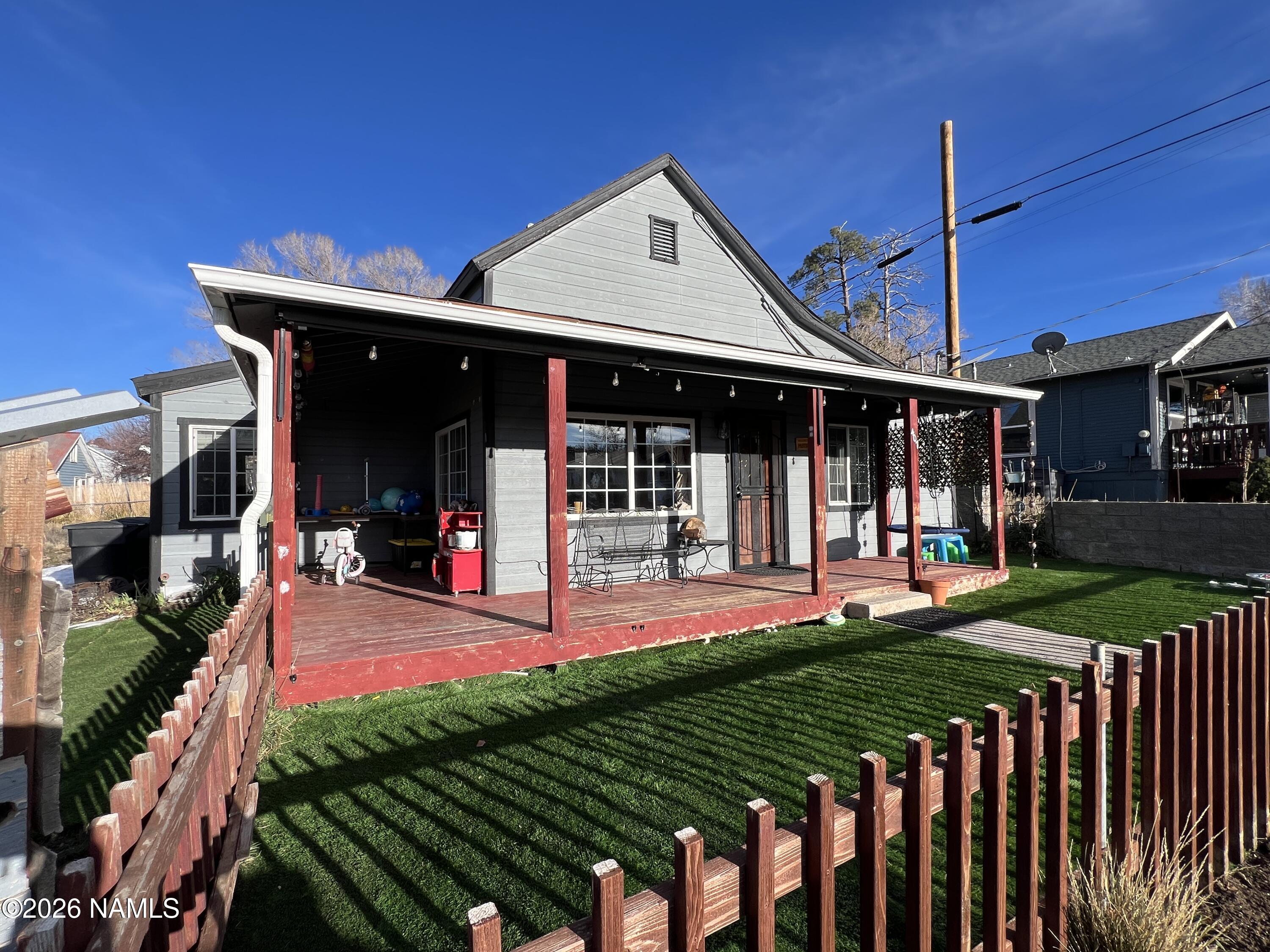 407 South 4th Street Williams, AZ 86046 - Photo 1 of 25 a front view of a house with porch and garden