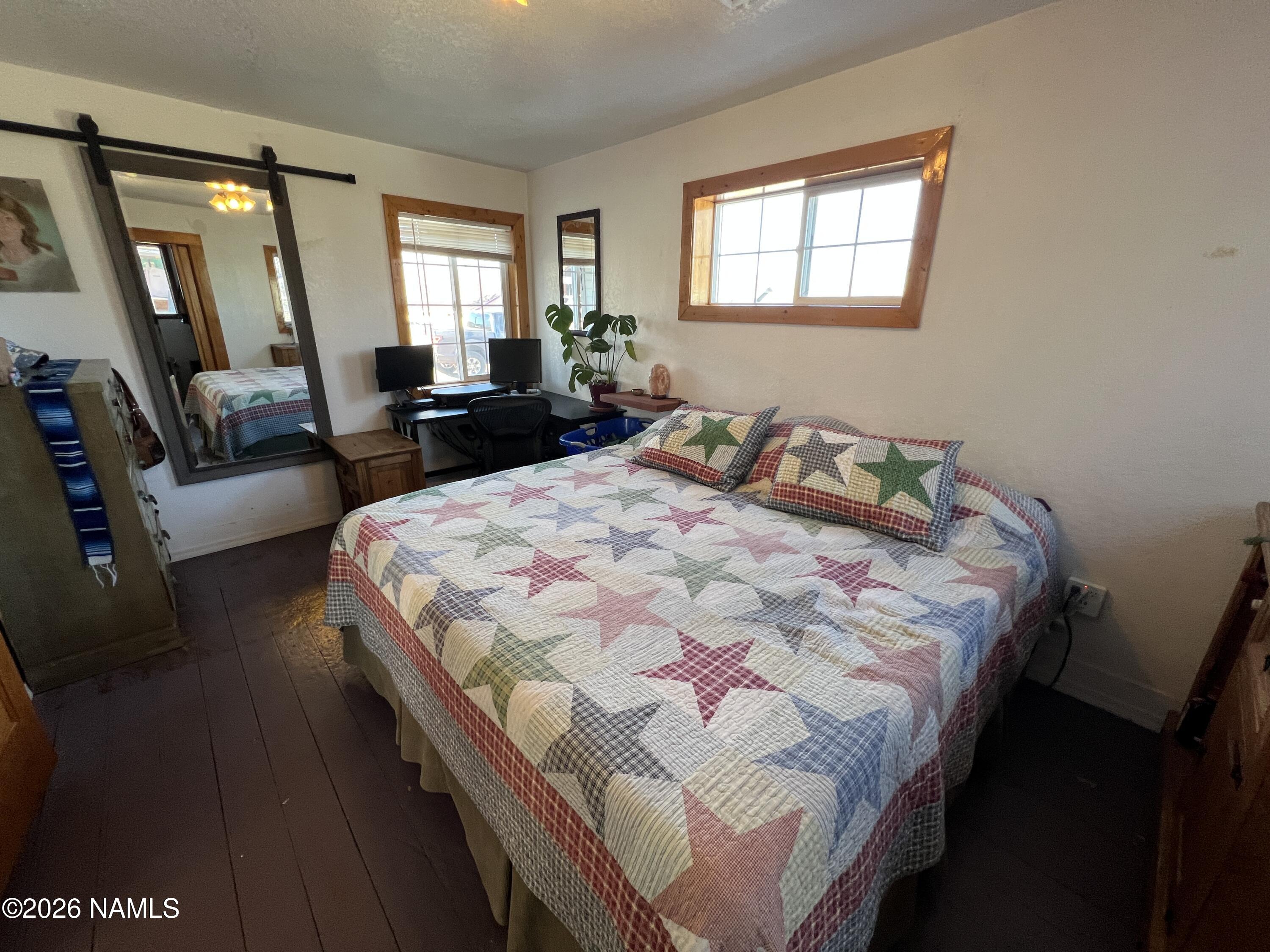 407 South 4th Street Williams, AZ 86046 - Photo 13 of 25 a bedroom with a bed a mirror and furniture
