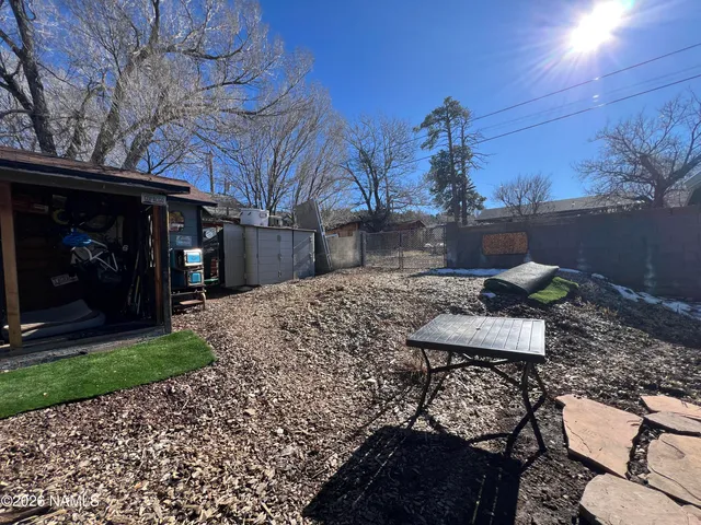 a view of a chairs and table in backyard