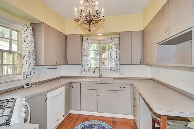 a kitchen with a sink stove and cabinets