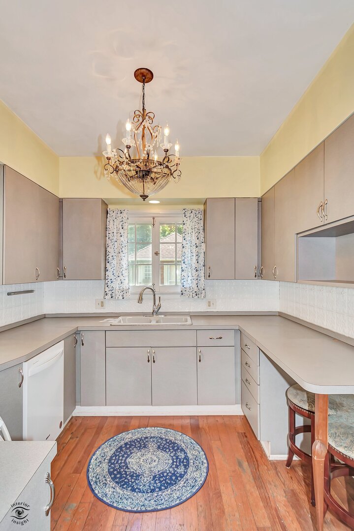 1096 South Wildwood Avenue Kankakee, IL 60901 - Photo 18 of 38 a kitchen with a white cabinets sink and stove