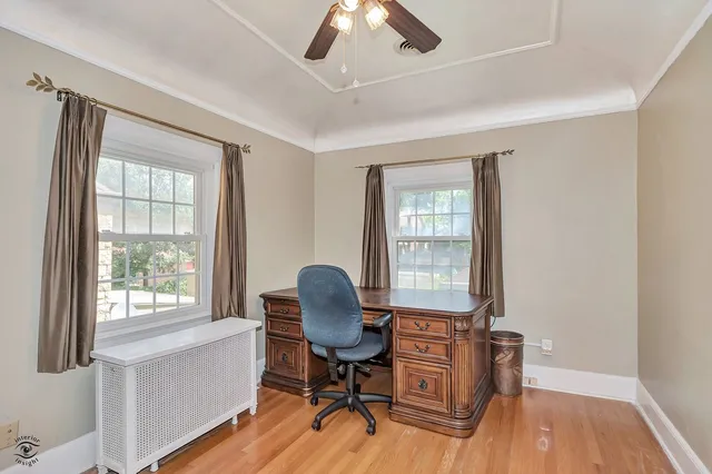 a view of a workspace with furniture and a window