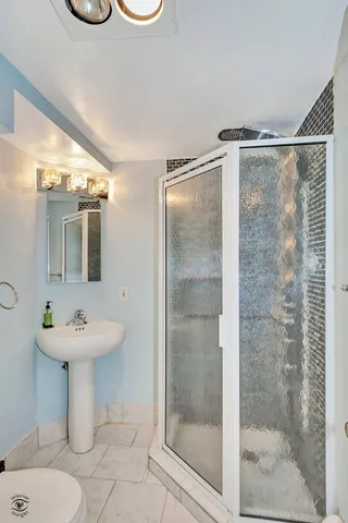 a bathroom with a sink mirror toilet and shower
