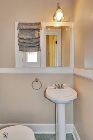 a bathroom with a sink a mirror and a toilet