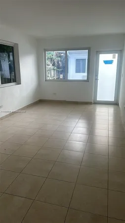 a view of an empty room with windows