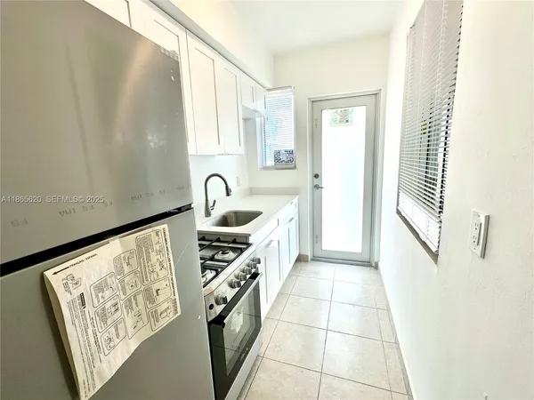 a kitchen with a sink a stove and cabinets